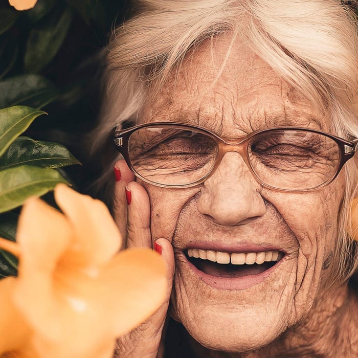 Older lady smiling in garden